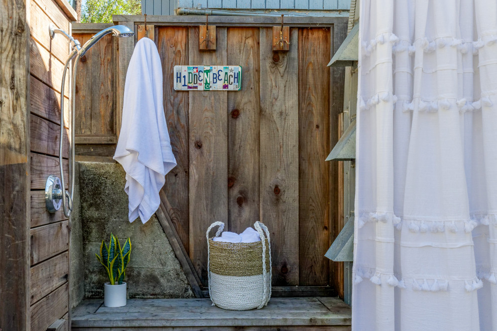 This is an example of a small beach style backyard patio in San Francisco with an outdoor shower and no cover.