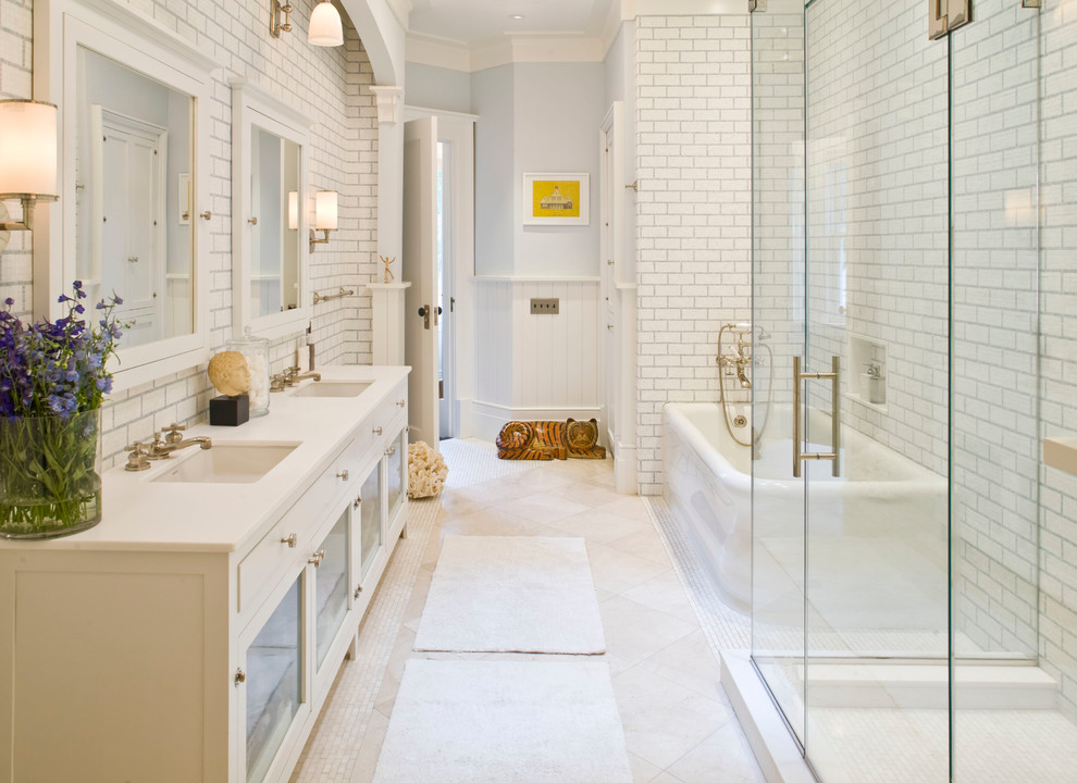 Inspiration for a traditional bathroom in New York with glass-front cabinets, white cabinets, a freestanding tub, a corner shower, white tile and subway tile.