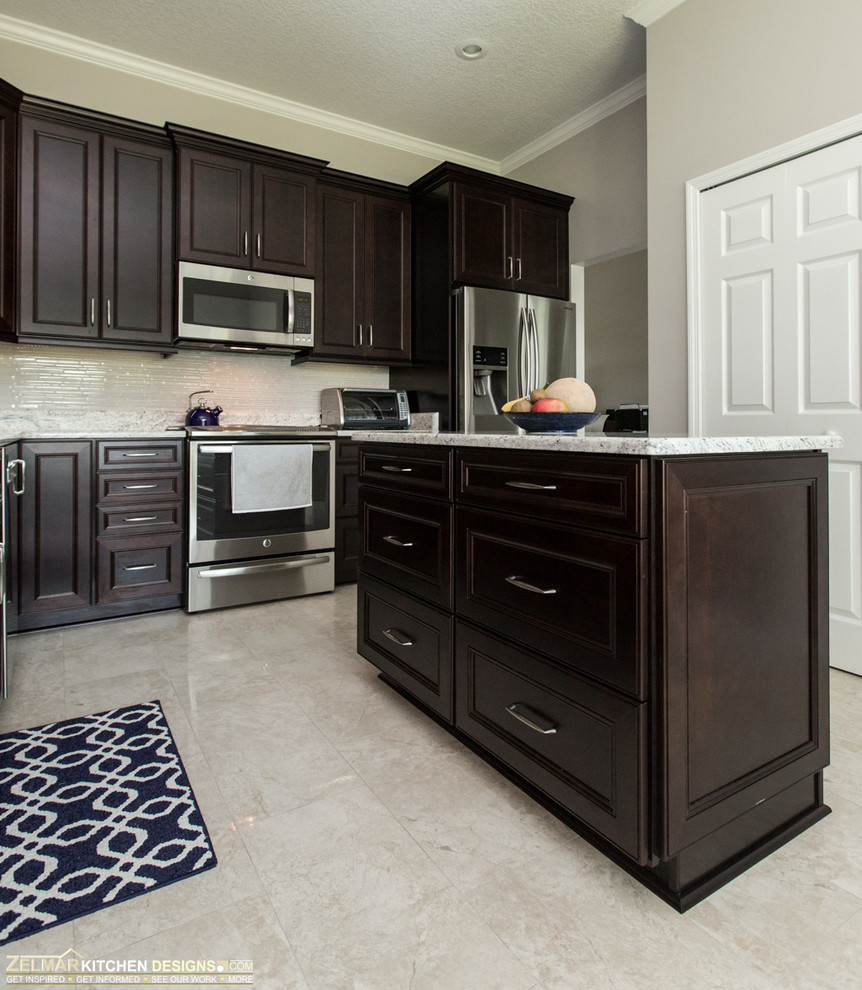 Inspiration for a mid-sized transitional l-shaped eat-in kitchen in Orlando with an undermount sink, recessed-panel cabinets, dark wood cabinets, granite benchtops, porcelain floors and with island.