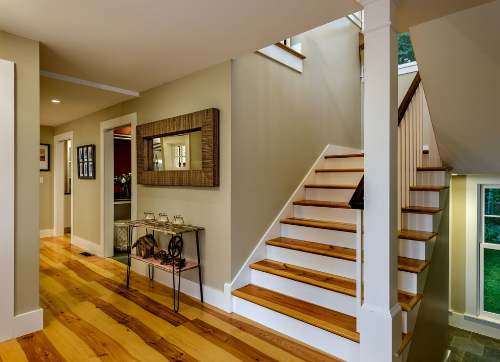 Design ideas for a mid-sized traditional foyer in Boston with beige walls, medium hardwood floors, a single front door and a medium wood front door.