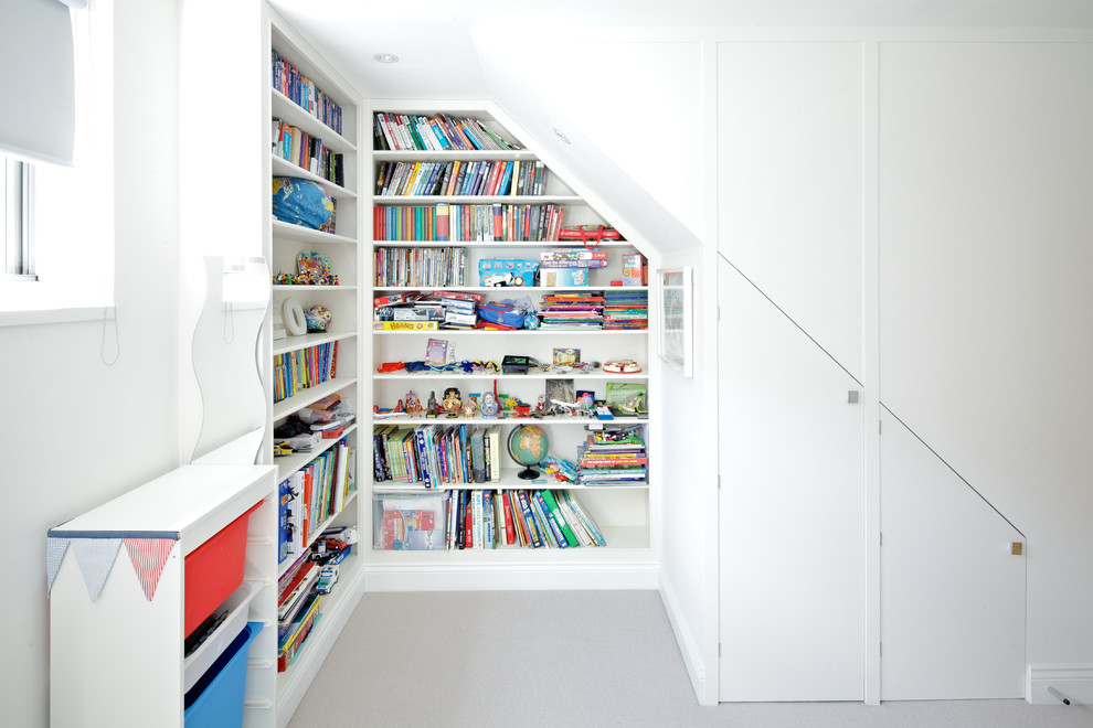 Inspiration for a contemporary gender-neutral kids' playroom for kids 4-10 years old in London with white walls.