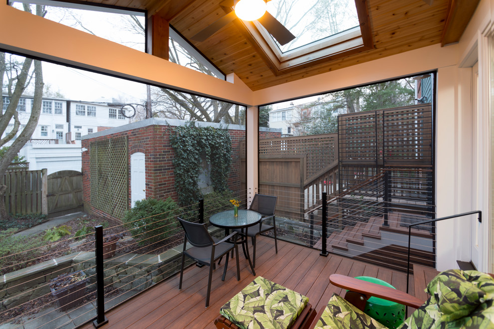 This is an example of a small modern backyard verandah in DC Metro with concrete pavers.