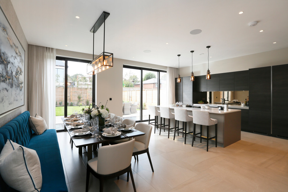 Inspiration for a contemporary eat-in kitchen in London with flat-panel cabinets, black cabinets, metallic splashback, panelled appliances, light hardwood floors, with island, beige floor and white benchtop.