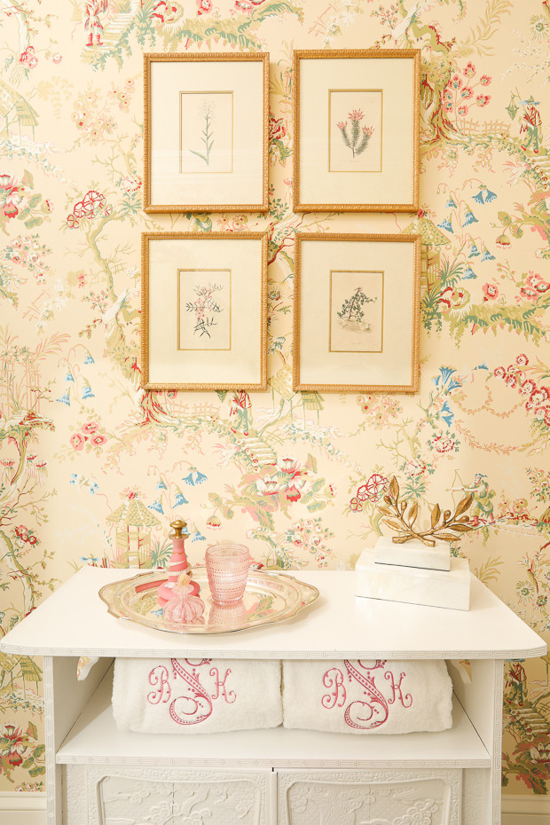 Inspiration for a small traditional powder room in Atlanta with glass-front cabinets, white cabinets, a two-piece toilet, white tile, pink walls, marble floors, an undermount sink and marble benchtops.