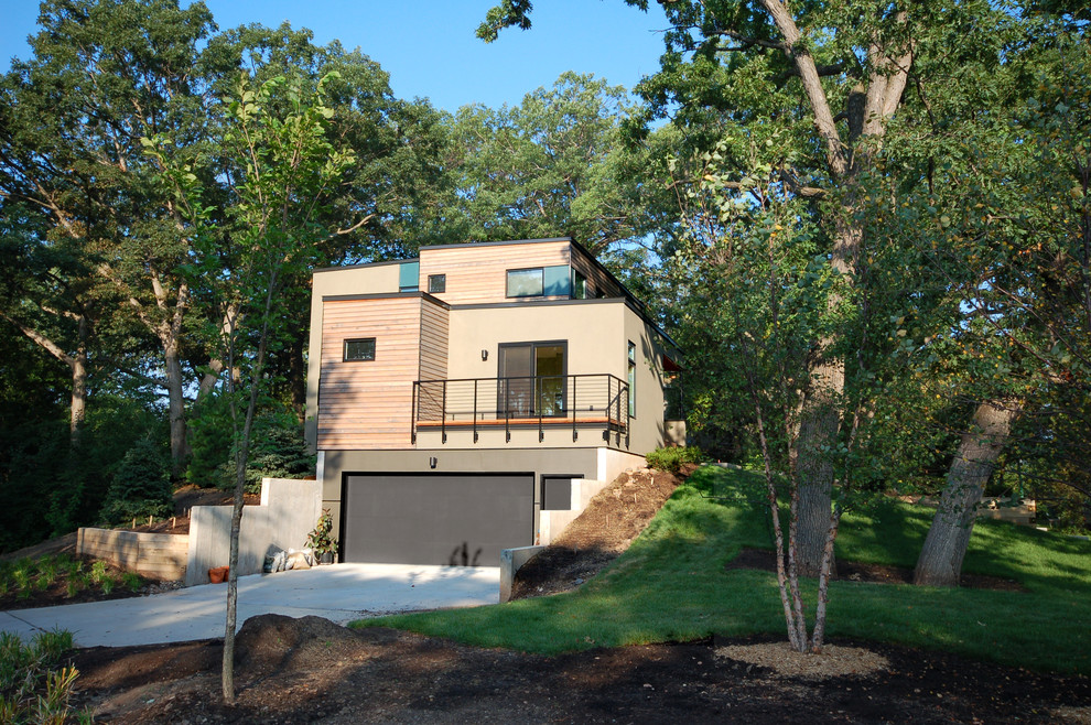 Photo of a contemporary two-storey exterior in Minneapolis with mixed siding.