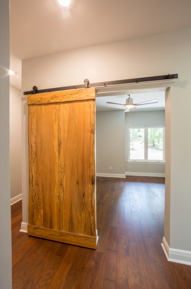 Inspiration for a mid-sized timeless medium tone wood floor and brown floor hallway remodel with beige walls