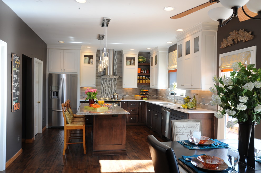 Example of a mid-sized eclectic l-shaped dark wood floor eat-in kitchen design in Cincinnati with an undermount sink, shaker cabinets, quartz countertops, gray backsplash, stainless steel appliances, an island and subway tile backsplash