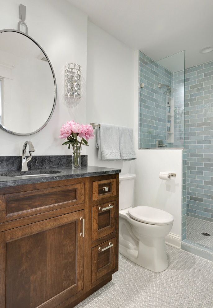 Inspiration for a small transitional 3/4 bathroom in Minneapolis with recessed-panel cabinets, dark wood cabinets, an open shower, blue tile, white walls, ceramic floors, an undermount sink, soapstone benchtops, white floor, an open shower, black benchtops, a single vanity and a built-in vanity.