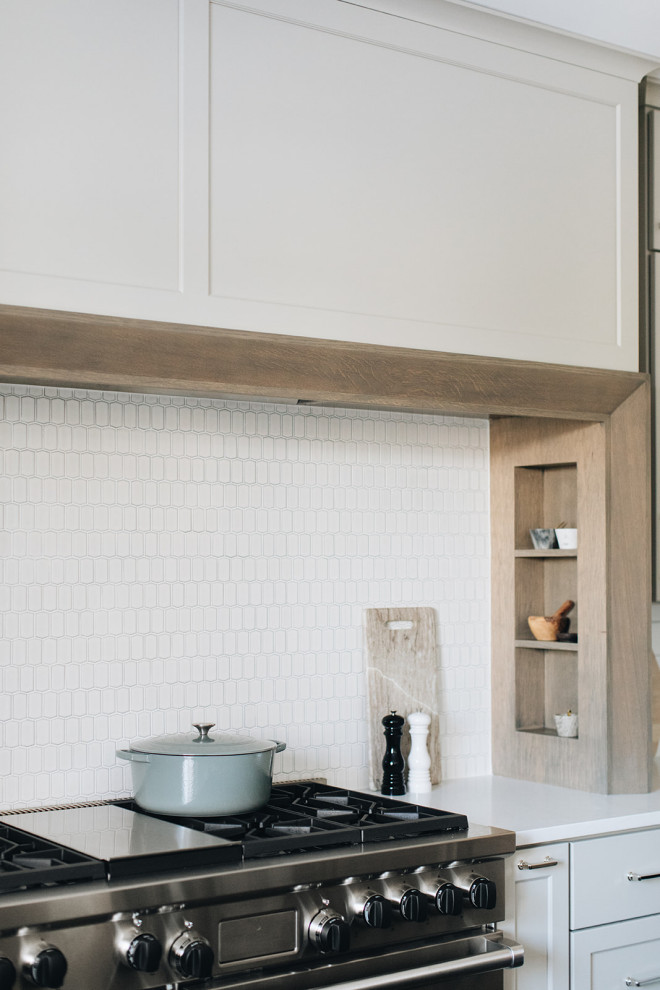 Mid-sized transitional dark wood floor eat-in kitchen photo in Chicago with a farmhouse sink, shaker cabinets, gray cabinets, quartz countertops, white backsplash, ceramic backsplash, paneled appliances, an island and white countertops