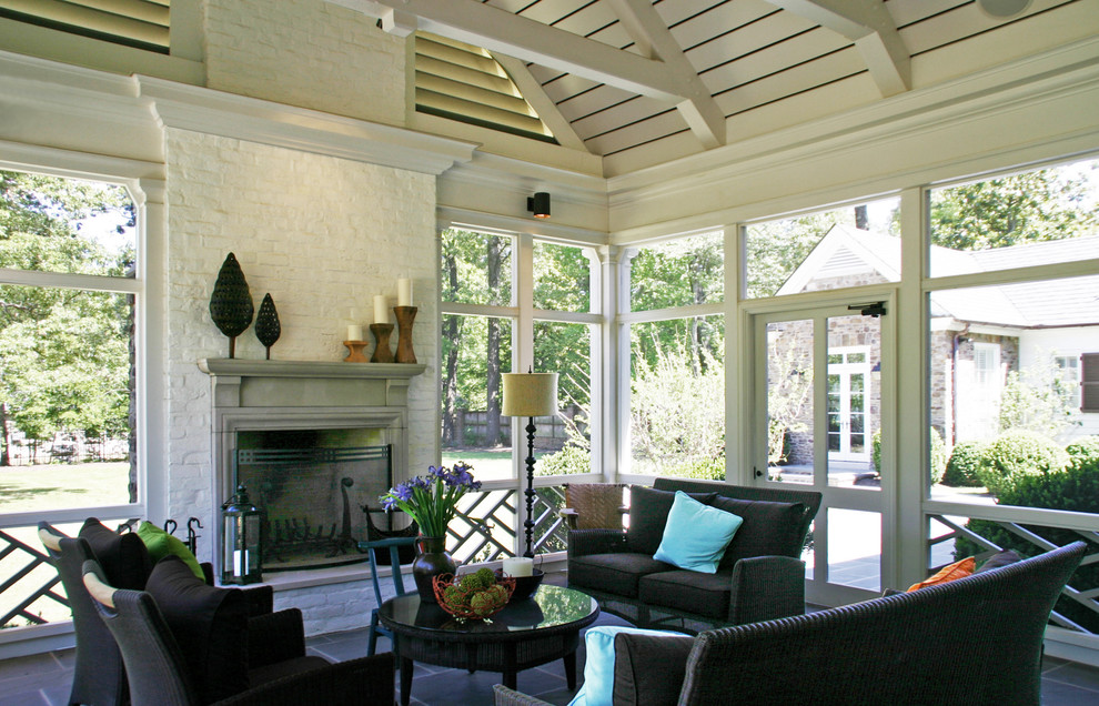 Photo of a large contemporary sunroom in Other with ceramic floors, a standard fireplace, a wood fireplace surround, a standard ceiling and brown floor.