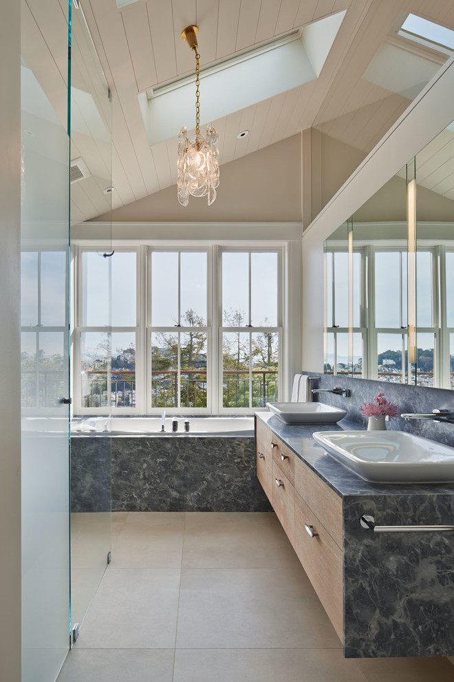 Design ideas for a transitional master bathroom in San Francisco with a vessel sink, cement tile, flat-panel cabinets, medium wood cabinets, a drop-in tub, a corner shower, beige walls, concrete floors and grey benchtops.