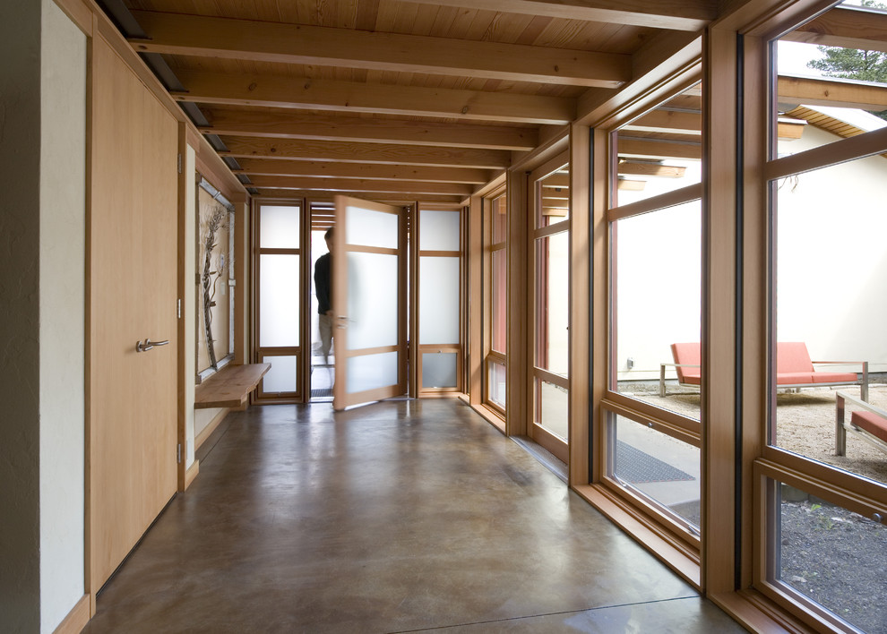 This is an example of a modern entryway in Seattle with concrete floors and grey floor.