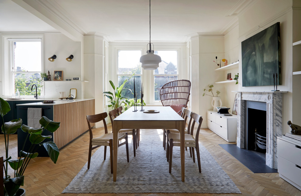 Danish medium tone wood floor dining room photo in Other with white walls