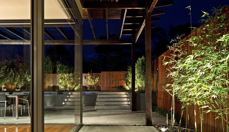 This is an example of a mid-sized contemporary backyard formal garden in Melbourne with a water feature and natural stone pavers.