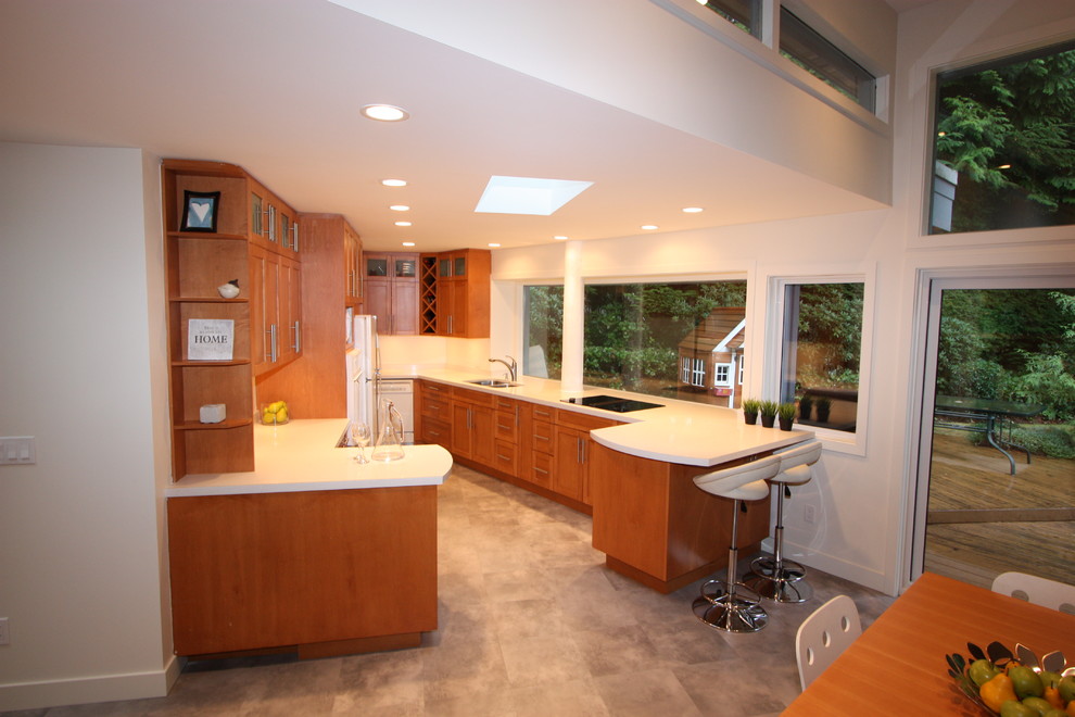 Inspiration for a large transitional u-shaped porcelain tile and white floor kitchen pantry remodel in Vancouver with an undermount sink, recessed-panel cabinets, brown cabinets, quartz countertops, white backsplash, white appliances and a peninsula