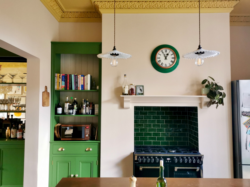 This is an example of a mid-sized transitional eat-in kitchen in Other with a farmhouse sink, shaker cabinets, green cabinets, copper benchtops, green splashback, ceramic splashback, panelled appliances, medium hardwood floors, with island, brown floor and brown benchtop.