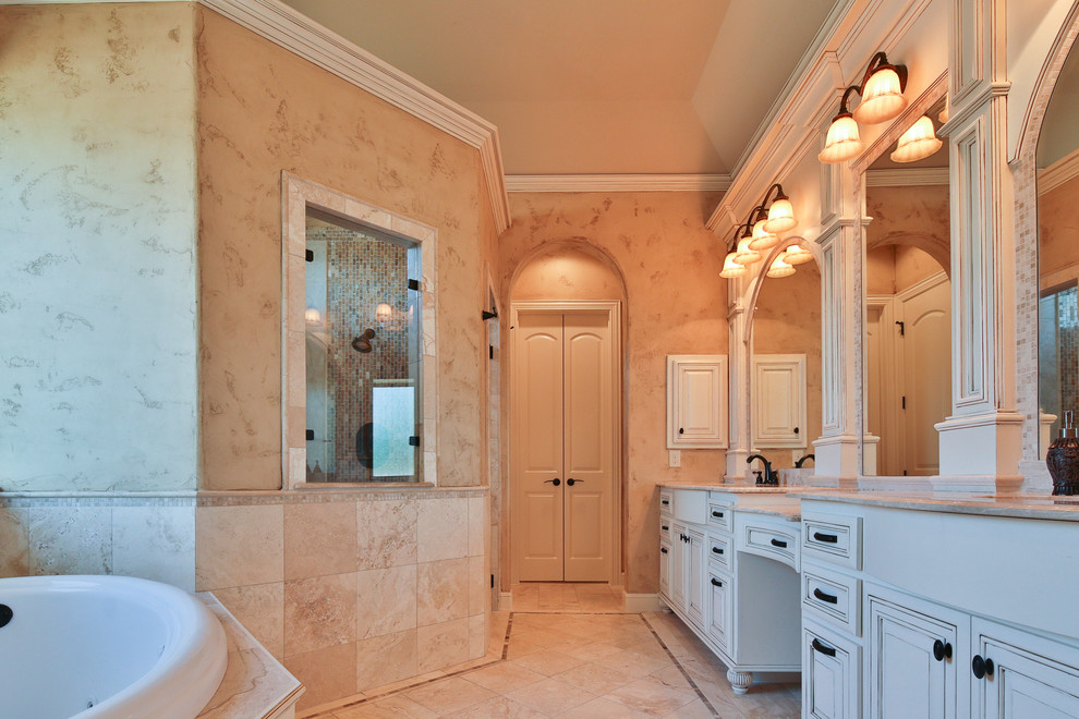 Design ideas for a large traditional master bathroom in Dallas with raised-panel cabinets, white cabinets, a drop-in tub, an alcove shower, beige tile, mosaic tile, beige walls, travertine floors, an undermount sink and granite benchtops.