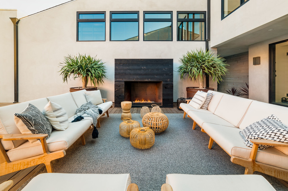 Expansive contemporary side yard deck in Los Angeles with a fire feature and no cover.