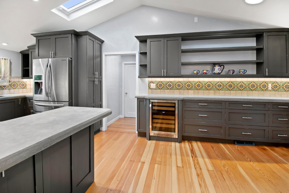 Small traditional u-shaped kitchen in San Francisco with an undermount sink, shaker cabinets, distressed cabinets, concrete benchtops, ceramic splashback, stainless steel appliances, medium hardwood floors, brown floor and grey benchtop.