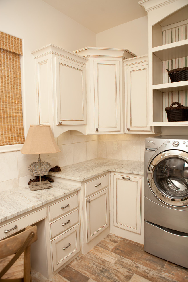 Large traditional u-shaped dedicated laundry room in Dallas with beaded inset cabinets, white cabinets, granite benchtops, white walls, vinyl floors, a side-by-side washer and dryer, multi-coloured floor and multi-coloured benchtop.