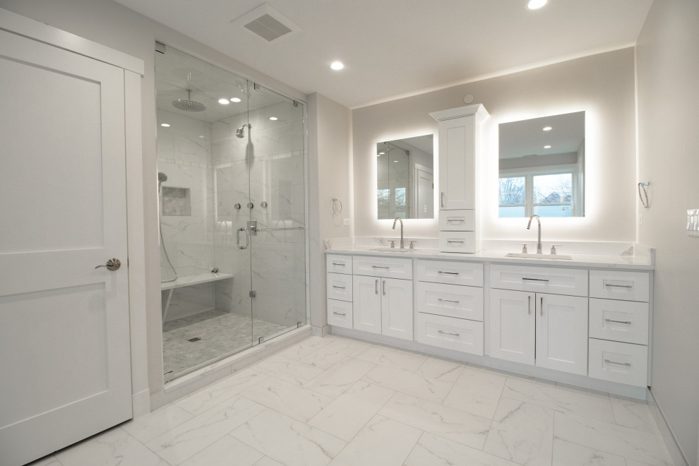 Design ideas for a large contemporary master bathroom in Chicago with shaker cabinets, white cabinets, a freestanding tub, an open shower, gray tile, porcelain tile, white walls, ceramic floors, quartzite benchtops, beige floor, white benchtops, a shower seat, a double vanity, a built-in vanity, a one-piece toilet, an undermount sink and a hinged shower door.