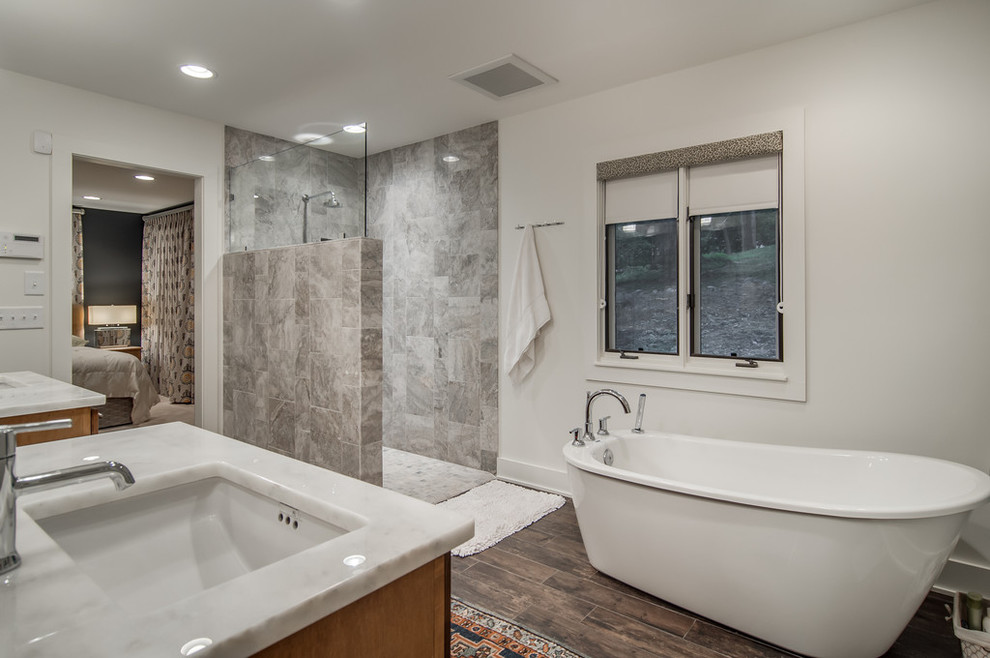 Photo of a modern master bathroom in Nashville with a freestanding tub, a curbless shower and beige walls.