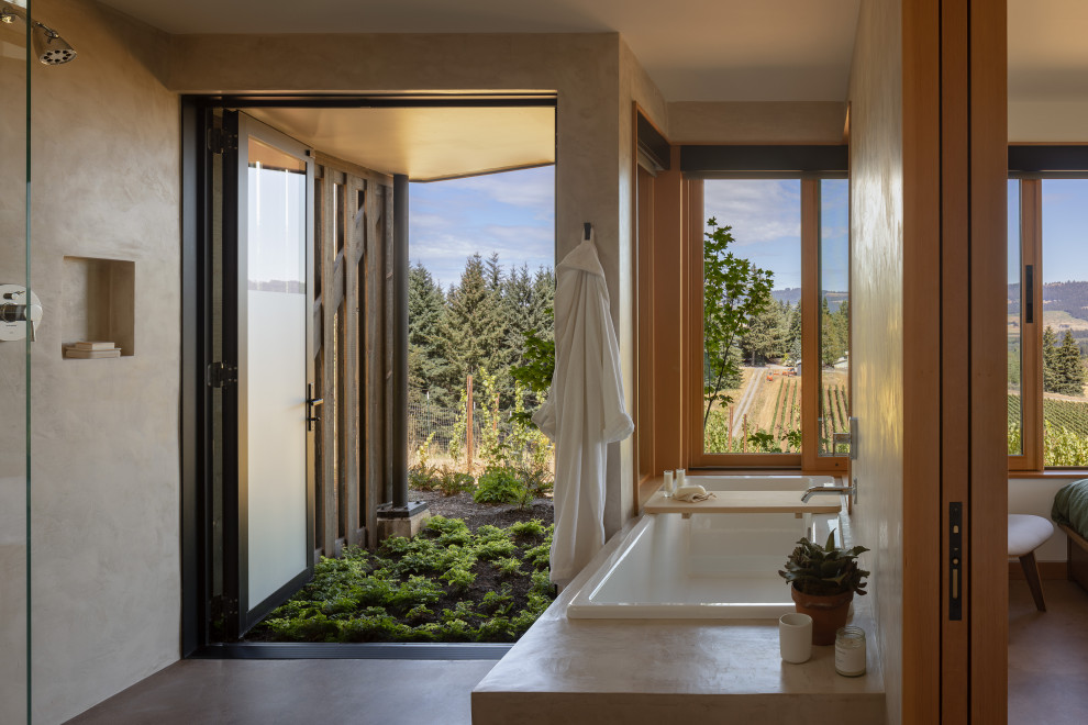 Inspiration for a mid-sized modern master concrete floor and gray floor drop-in bathtub remodel in Portland with beige walls