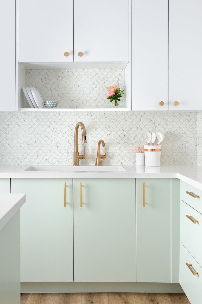 Large eclectic u-shaped medium tone wood floor and brown floor open concept kitchen photo in Toronto with a drop-in sink, flat-panel cabinets, gray backsplash, cement tile backsplash, white appliances and an island