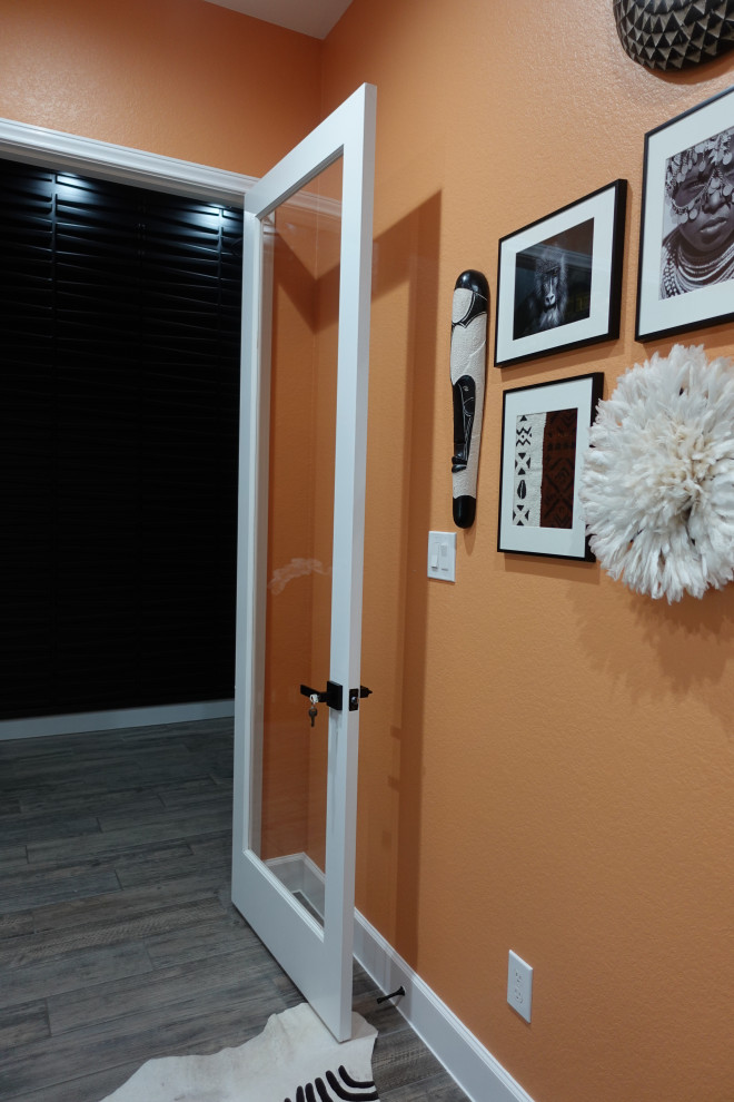 Idee per un piccolo ufficio moderno con pareti arancioni, pavimento con piastrelle in ceramica, nessun camino, scrivania autoportante e pavimento grigio