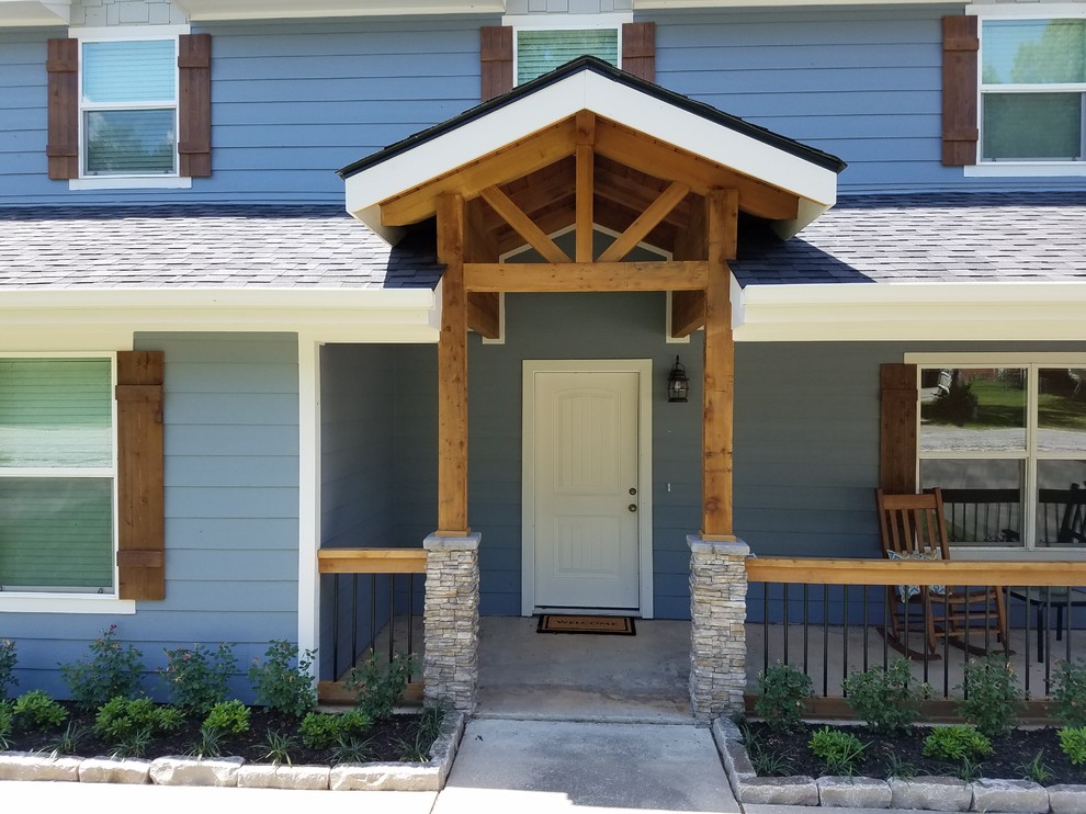 This is an example of a mid-sized arts and crafts front yard verandah in Houston with concrete slab and a roof extension.