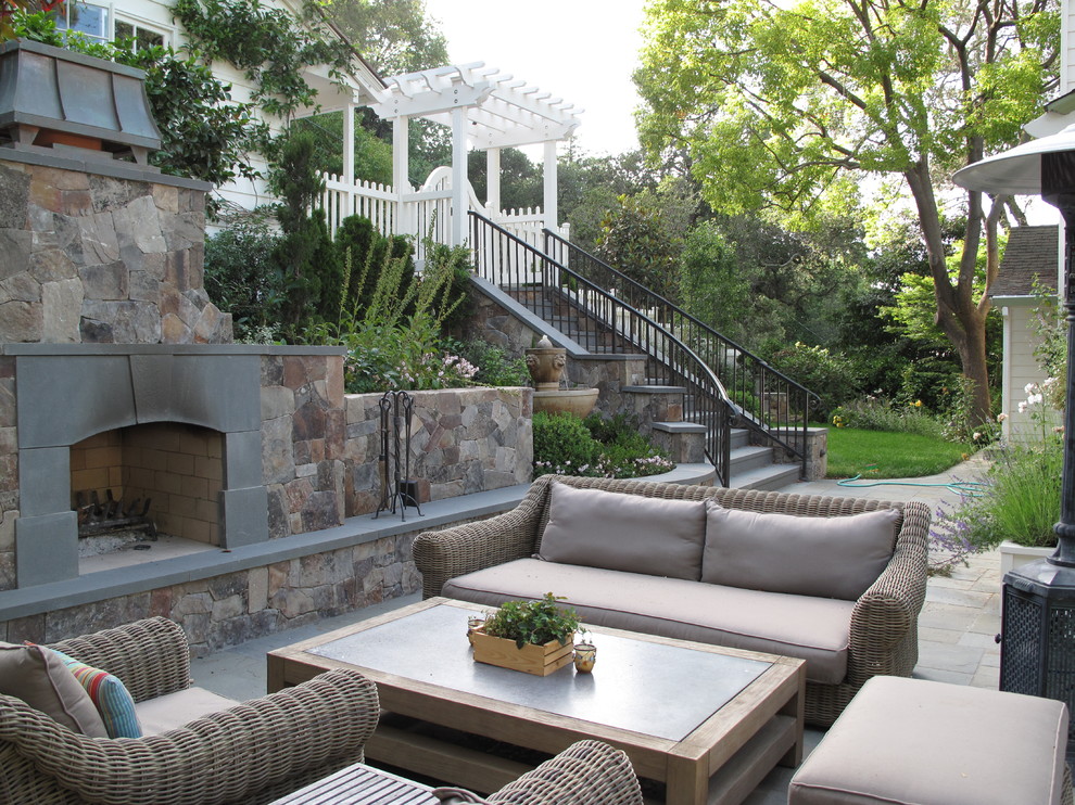 This is an example of a traditional patio in San Francisco with a fire feature and a pergola.