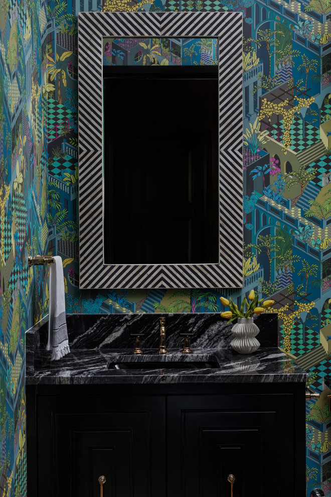 Inspiration for an eclectic powder room in Austin with black cabinets and wallpaper.