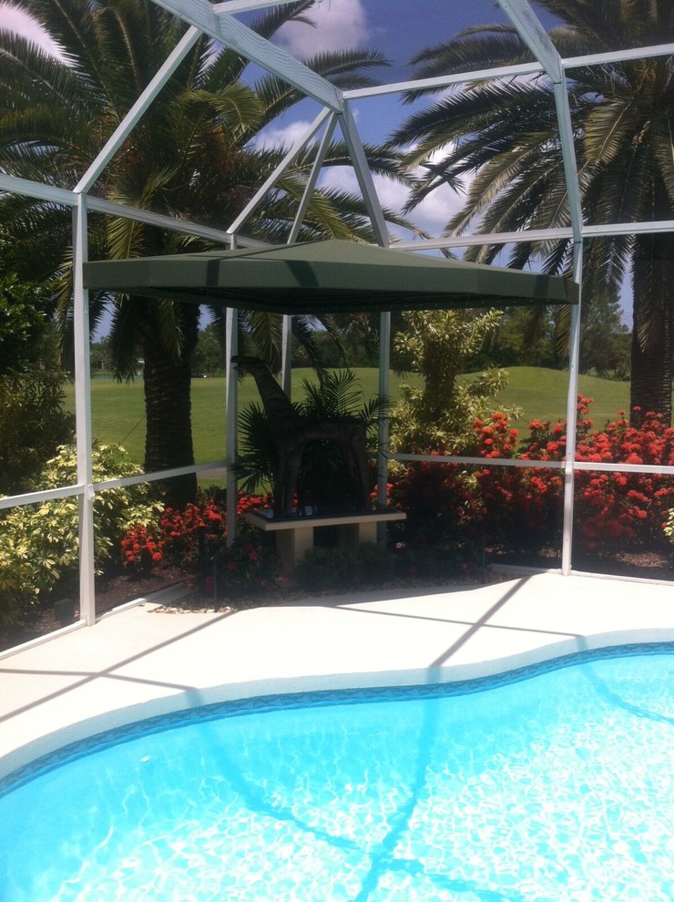 Mid-sized mediterranean indoor custom-shaped pool in Tampa with concrete slab.
