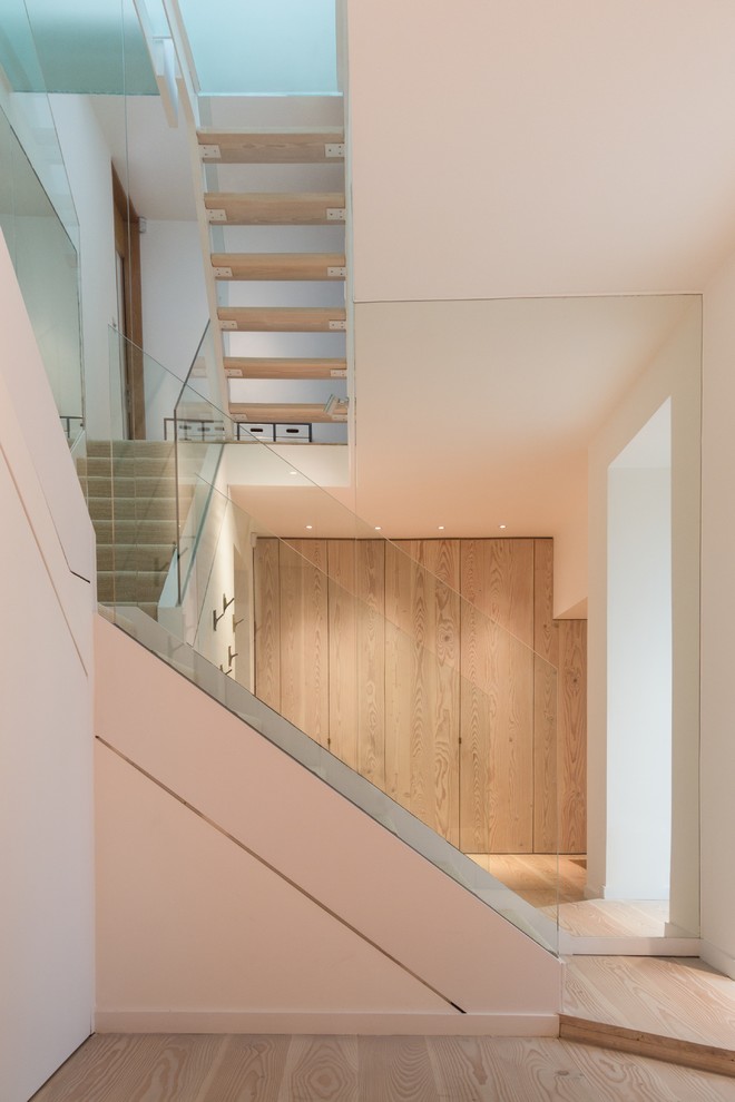 Design ideas for a mid-sized contemporary wood l-shaped staircase in London with open risers.
