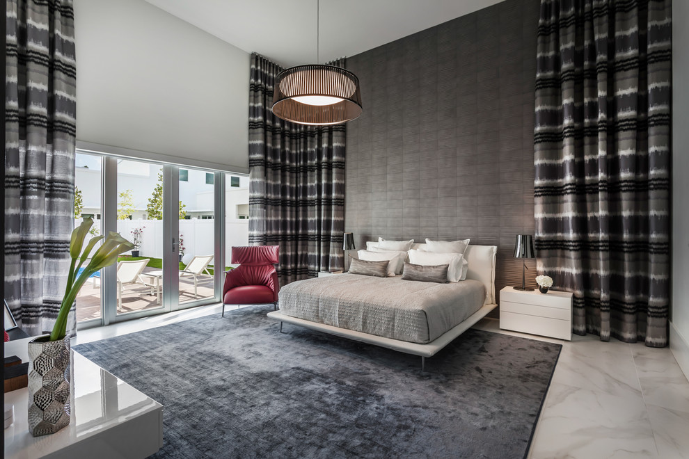 This is an example of a contemporary master bedroom in Miami with grey walls.