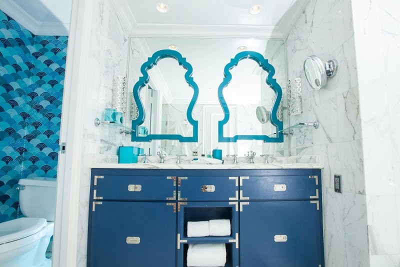 Photo of a mid-sized beach style master bathroom in Miami with marble benchtops, blue walls and marble floors.