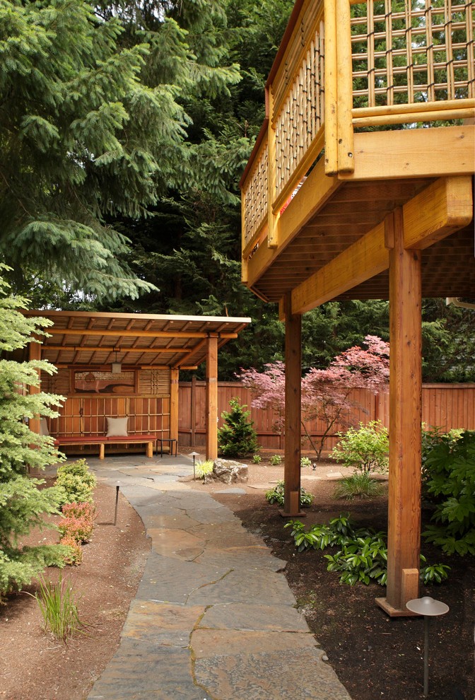 This is an example of an asian backyard garden in Portland with natural stone pavers.