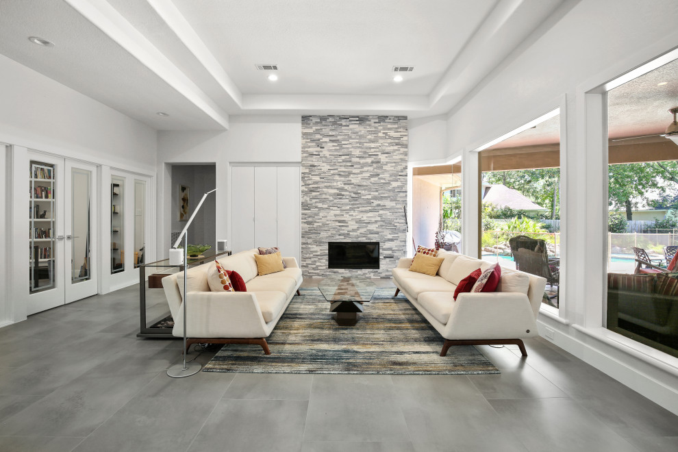 Inspiration for a mid-sized contemporary formal open concept living room in Houston with grey walls, ceramic floors, a standard fireplace, no tv, grey floor and recessed.