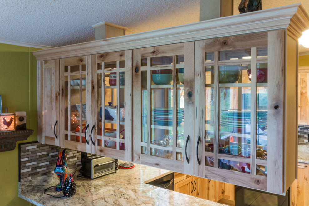 Inspiration for a mid-sized u-shaped cement tile floor and beige floor eat-in kitchen remodel with an undermount sink, shaker cabinets, light wood cabinets, granite countertops, glass tile backsplash, black appliances, a peninsula and beige countertops