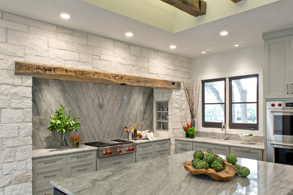 Inspiration for a transitional l-shaped open plan kitchen in Austin with an undermount sink, recessed-panel cabinets, green cabinets, quartzite benchtops, green splashback, stone slab splashback, stainless steel appliances, medium hardwood floors and with island.