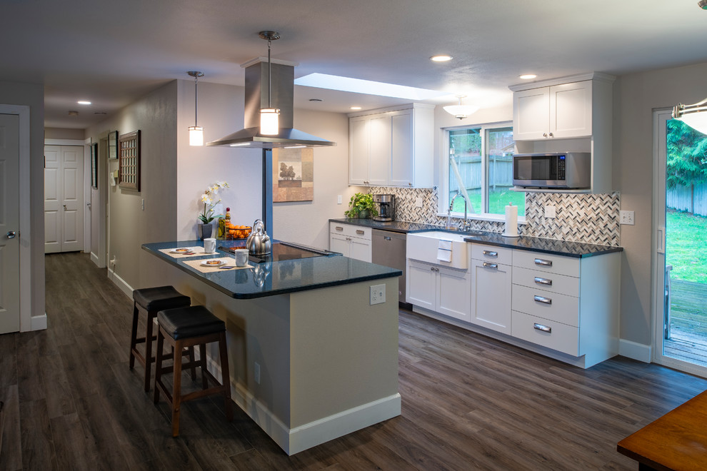 This is an example of a mid-sized contemporary galley kitchen in Seattle with shaker cabinets, white cabinets, quartz benchtops, grey splashback, laminate floors, grey floor and blue benchtop.