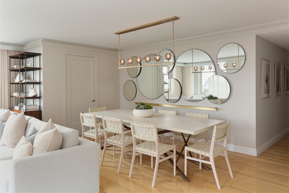 Photo of a contemporary open plan dining in New York with grey walls, light hardwood floors and beige floor.