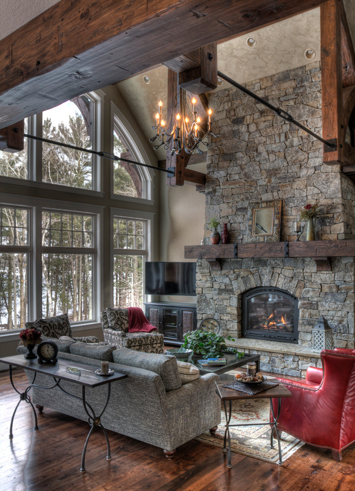 Photo of a country formal living room in Minneapolis with a standard fireplace and a stone fireplace surround.