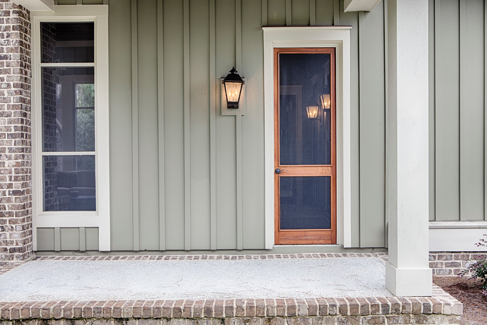 Design ideas for a large traditional two-storey green exterior in Charleston with concrete fiberboard siding.