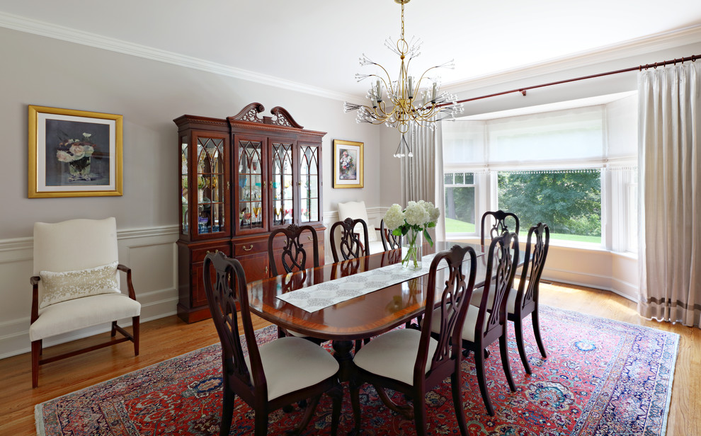 Mid-sized traditional separate dining room in New York with beige walls, medium hardwood floors, no fireplace and brown floor.
