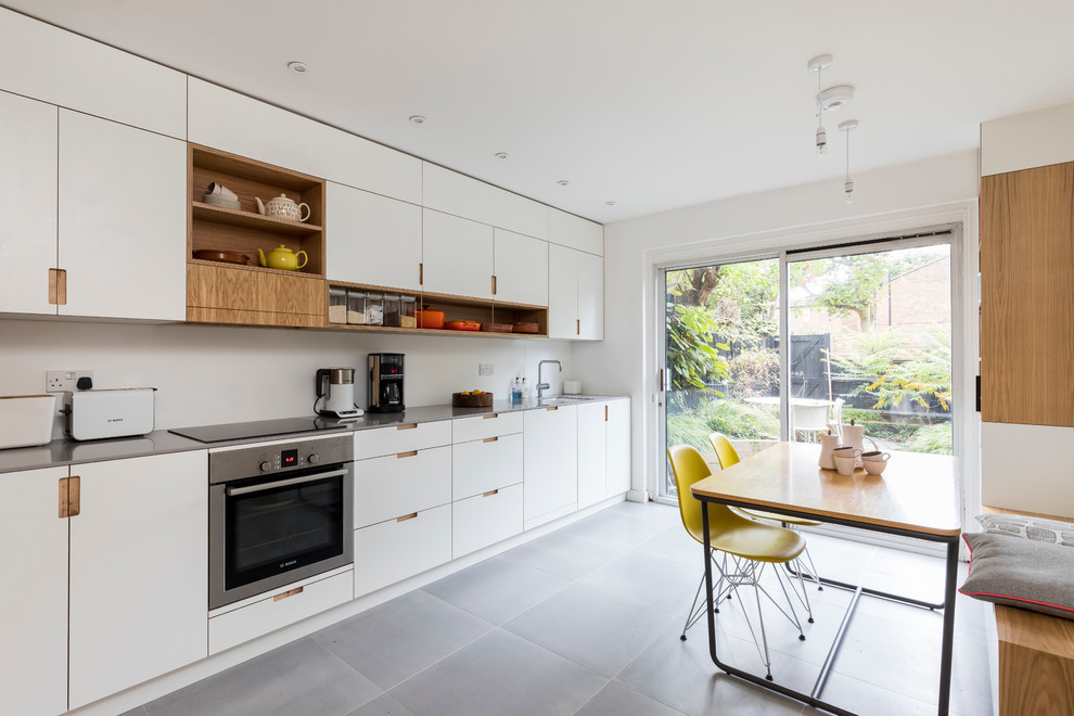 Mid-sized modern single-wall eat-in kitchen in London with quartz benchtops.