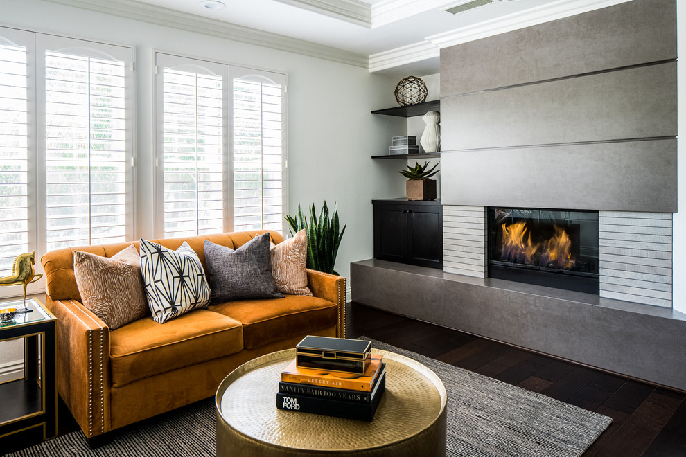 Inspiration for a transitional living room in Orange County with white walls, dark hardwood floors, a ribbon fireplace and brown floor.
