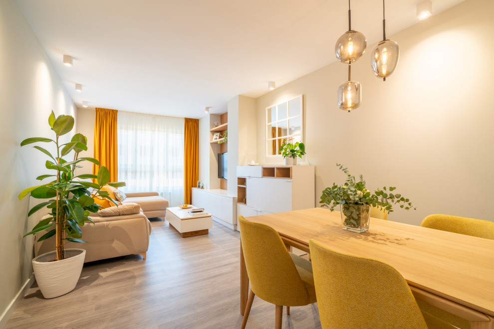 Photo of a medium sized scandi enclosed living room curtain in Other with beige walls, laminate floors, a wall mounted tv and grey floors.