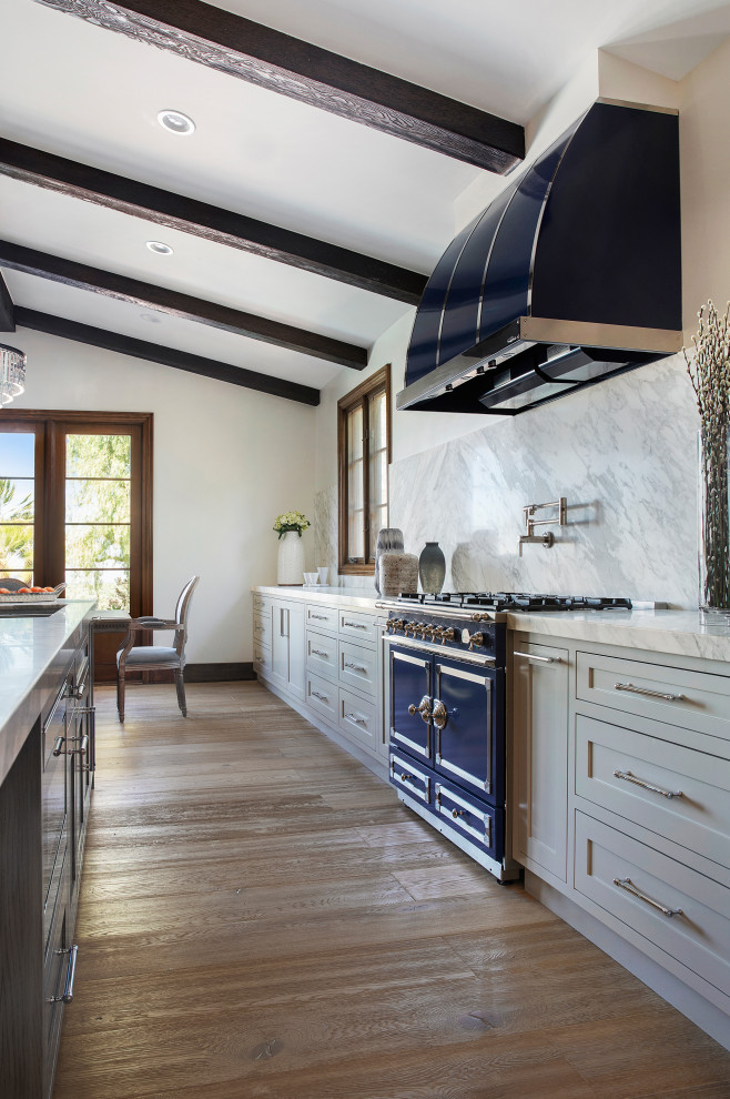 Inspiration for a transitional kitchen remodel in Orange County with shaker cabinets, gray cabinets, white backsplash and an island