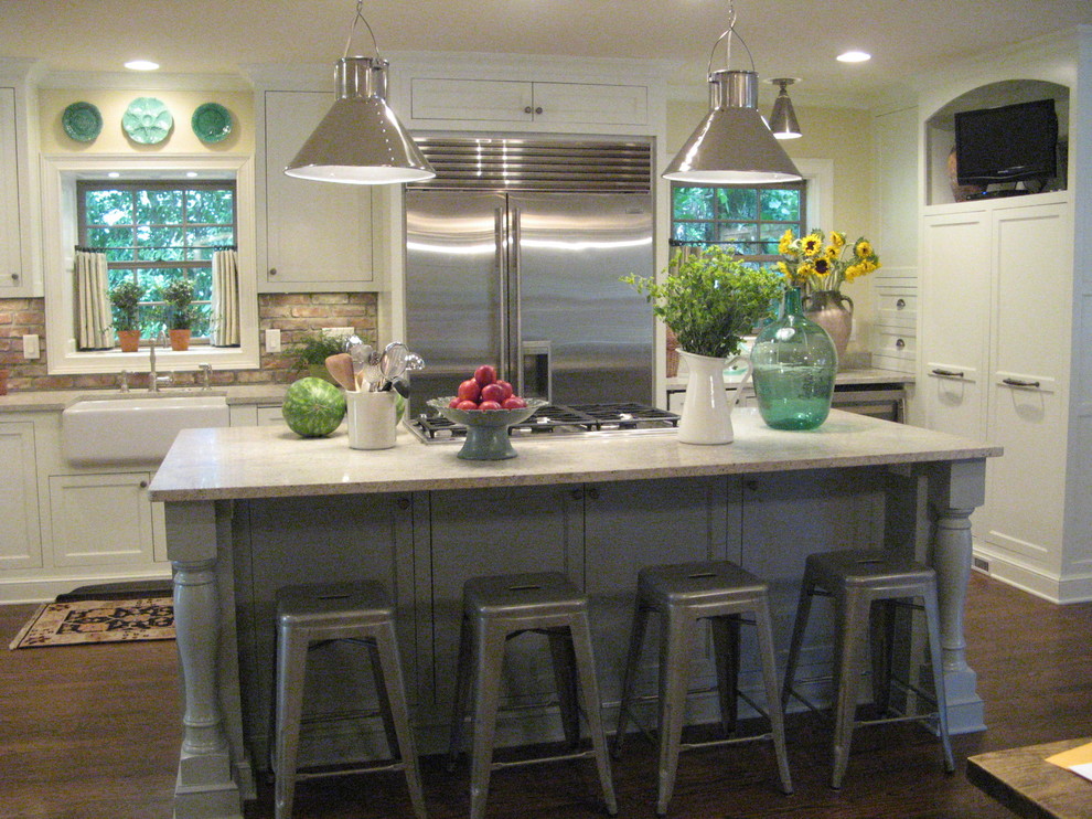 Photo of a country open plan kitchen in Atlanta with a farmhouse sink, white cabinets, marble benchtops, grey splashback, stone tile splashback and stainless steel appliances.
